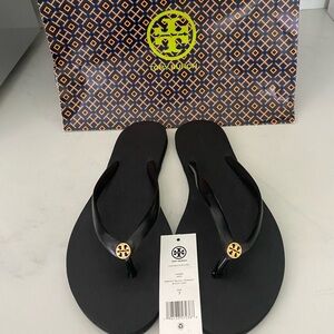 Tory Burch thin flip flops in black.